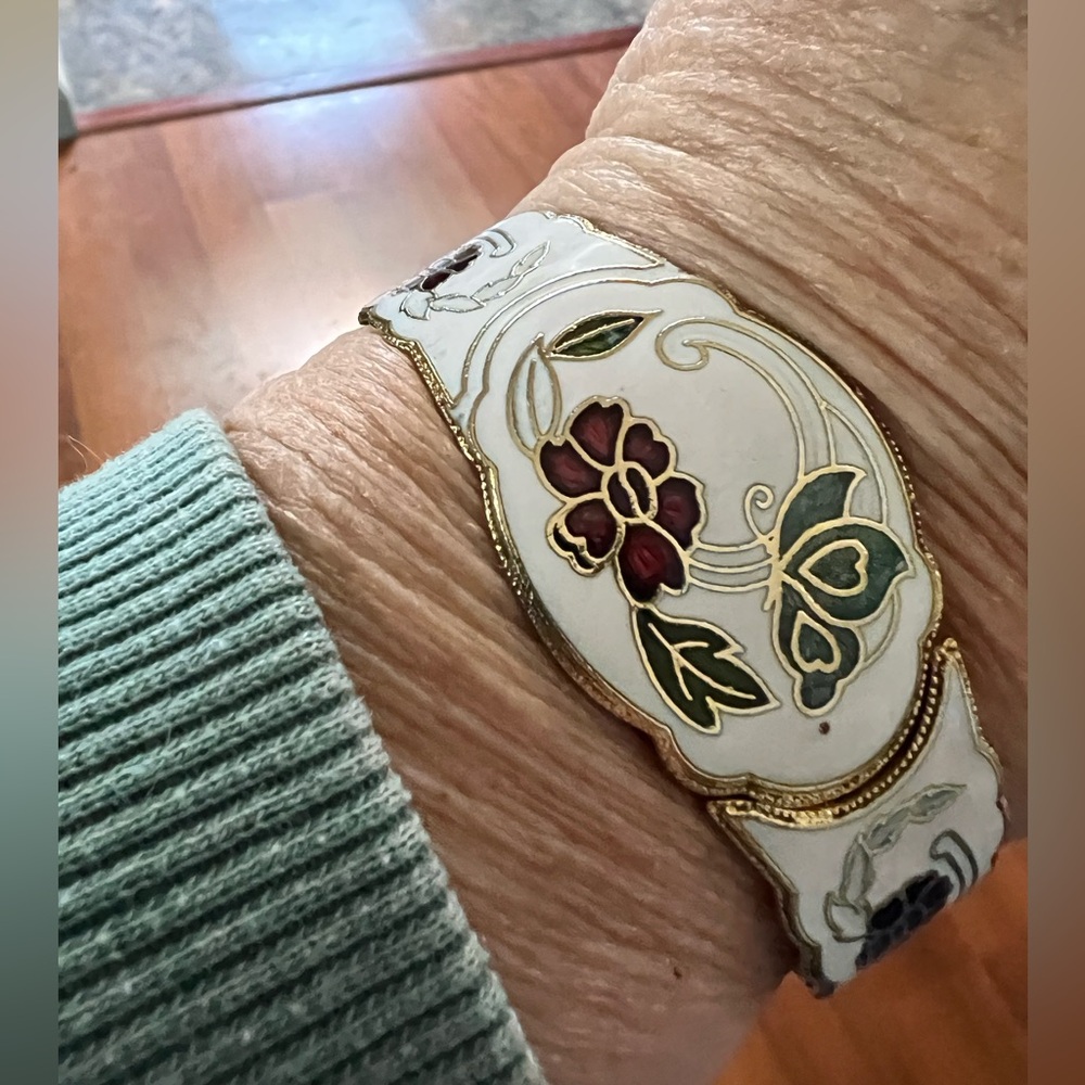 White vintage cloisonné 1-1/2” wide hinged flower and butterfly gold-tone bangle